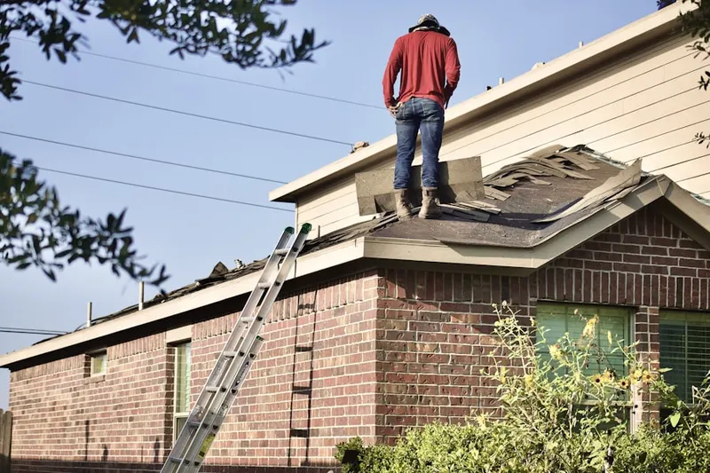 Professional roofer working on a residential roof in Tanner